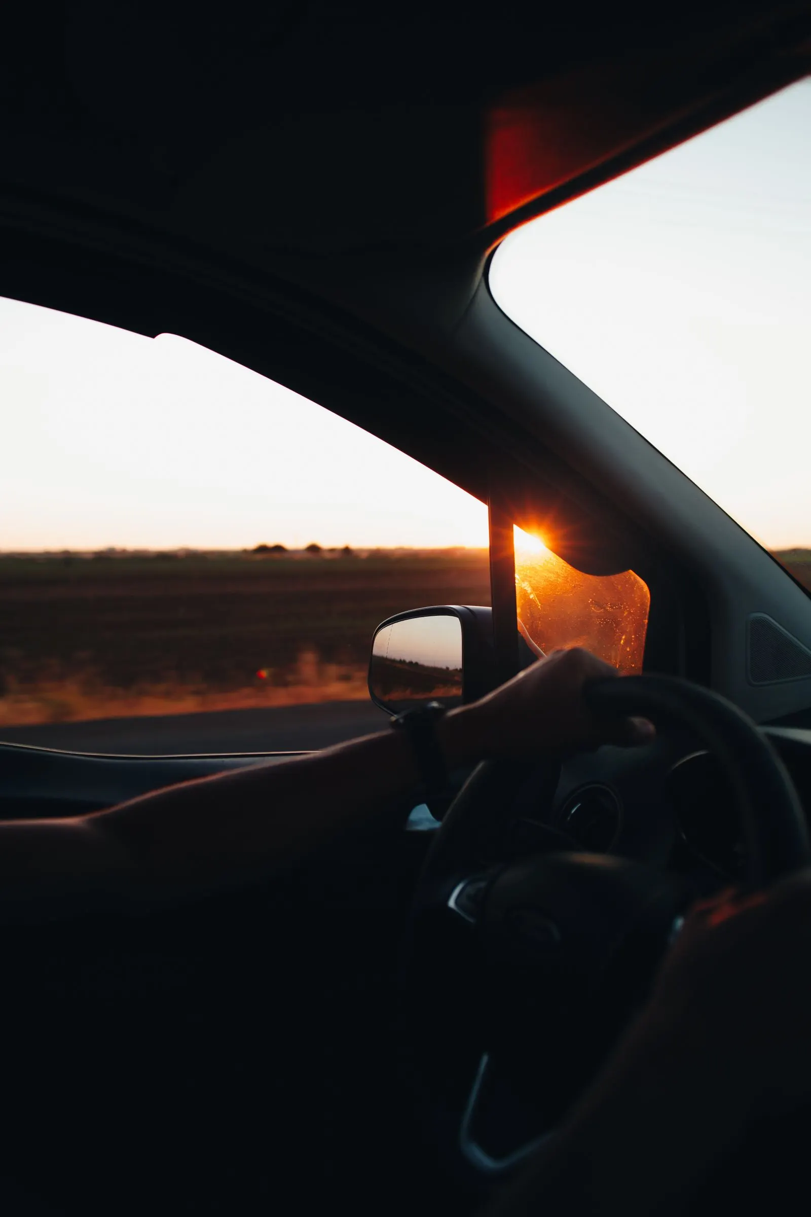 View from behind the wheel at sunset