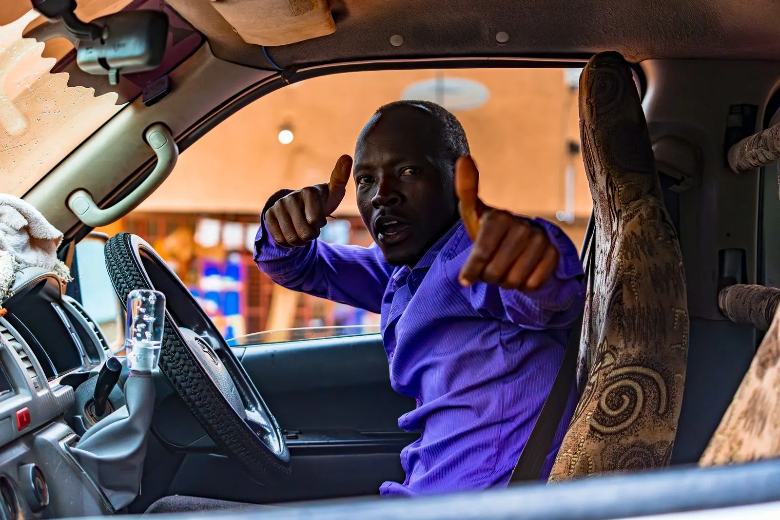Driver smiling inside his car