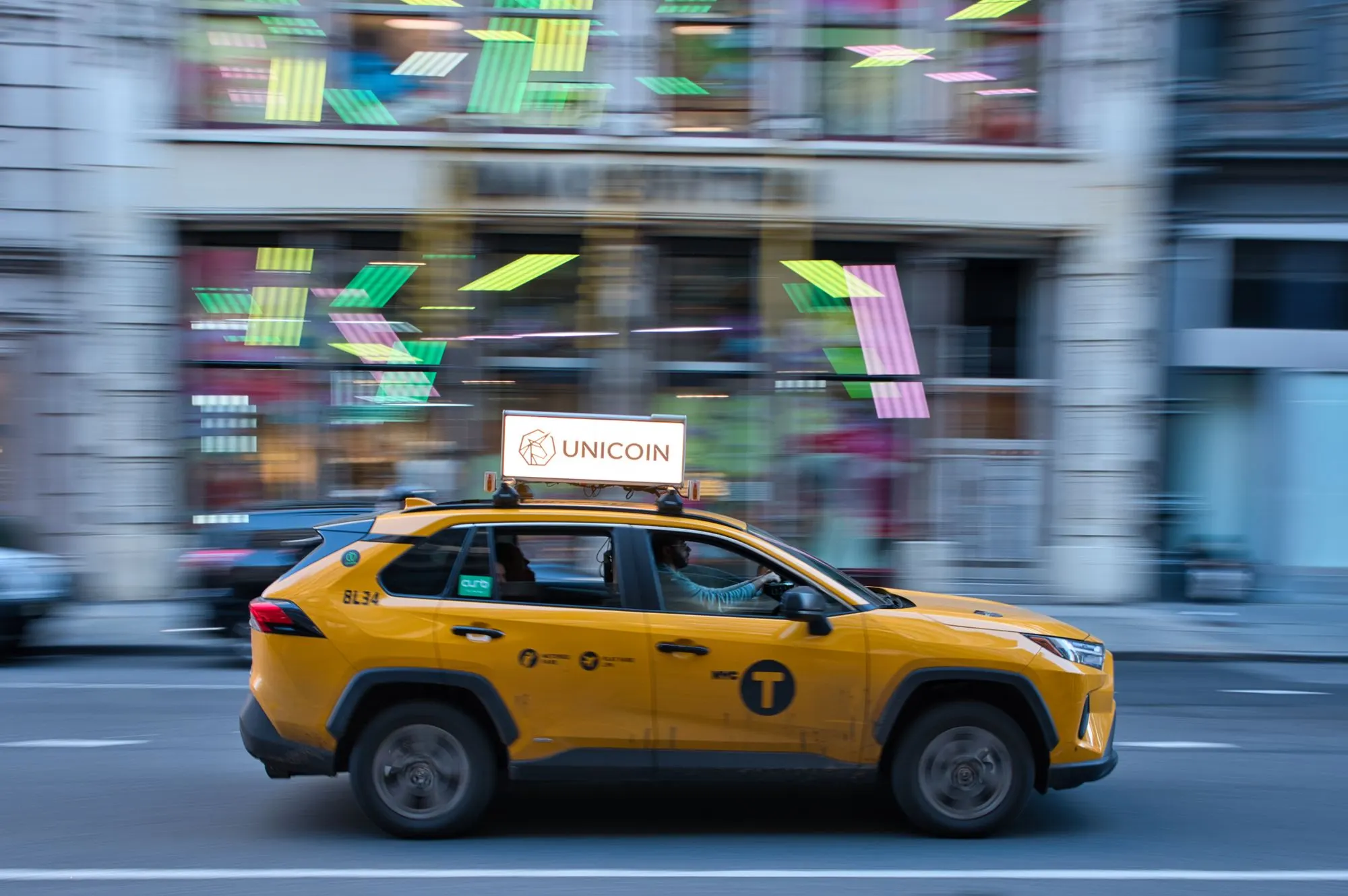 A cab moving through city traffic at night