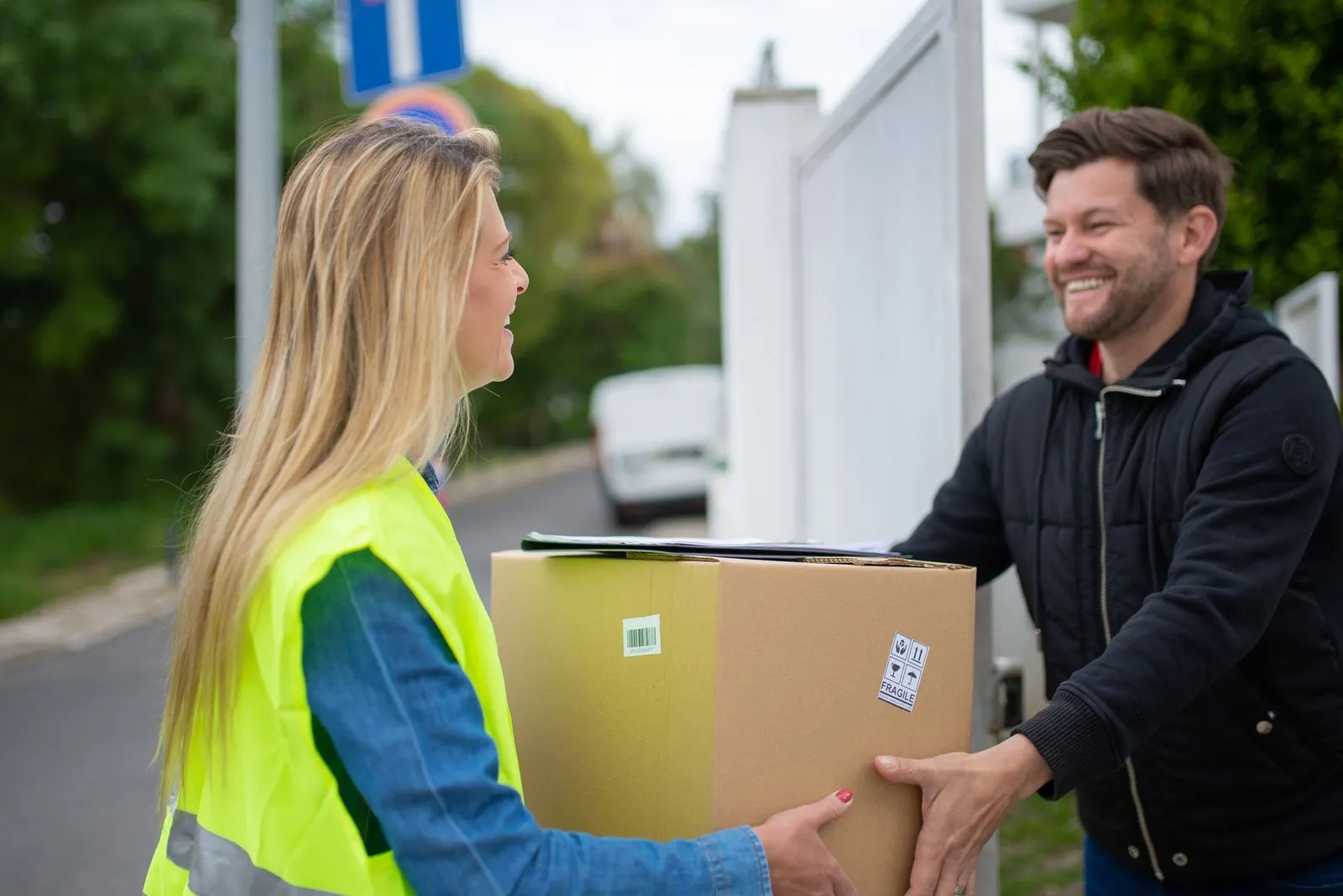 Courier handing a package to a customer